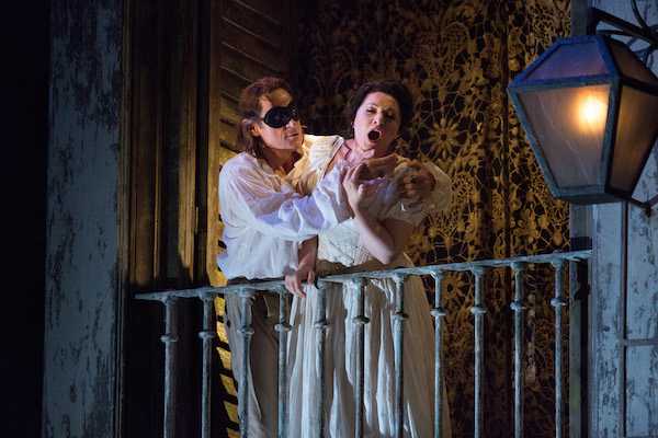 Simon Keenlyside and Hibla Gerzmava in the opening scene at the Metropolitan Opera, photo Marty Sohl